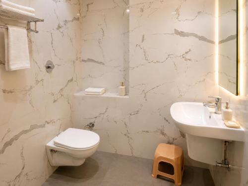 a bathroom with a toilet and a sink at Hotel Vasant - Premium Hotel in Gajraula - All AC Rooms with Restaurant - Free Wi-fi & Parking - Banquet in Gajraula