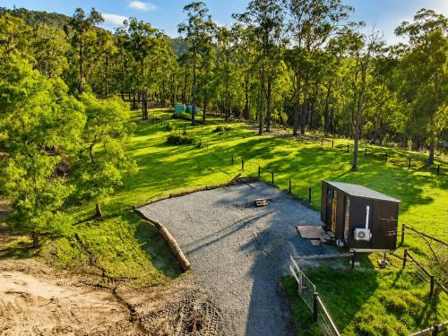 an overhead view of a farm with a shed and trees at Gum Tree by Tiny Away in Dixons Creek