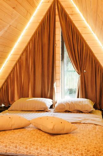two beds in a room with a large window at Давидів Хутір in Zhytomyr