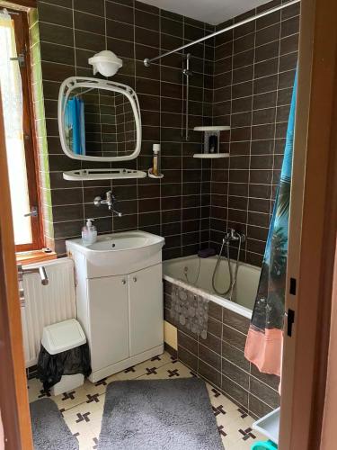 a bathroom with a sink and a bath tub at Chata na Polane in Vyšné Hágy