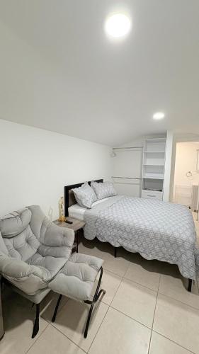 a bedroom with a bed and a bed and a chair at HollywoodCozyStudio in Hollywood