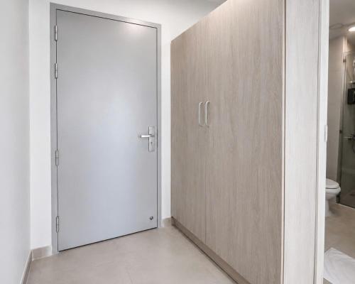 a bathroom with a sliding door and a toilet at Sleep & Go Capsule Hostel Bui Vien District 1 in Ho Chi Minh City
