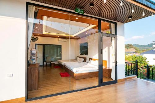 a bedroom with a bed and a balcony at Home Mộc Mer Mộc Châu in Mộc Châu