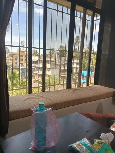 a room with a table and a window with a view at Grantley -Beach hotel Alibag in Alībāg