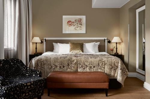 a bedroom with a bed and a chair at Hotel Haven in Helsinki