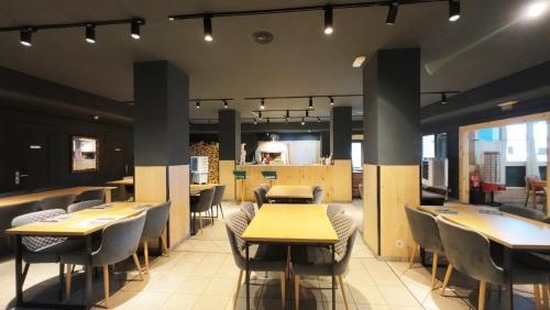ein Restaurant mit Tischen und Stühlen in einem Raum in der Unterkunft Hotel Alaiz in Beriáin