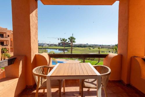a table and chairs on a balcony with a view at Serena Golf Apartments in Los Alcázares