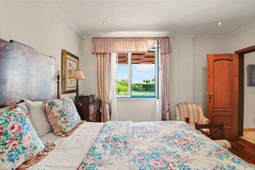 a bedroom with a bed and a window at Rocha's House - Setúbal in Setubal