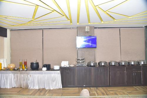 a room with a table with many pots and pans at Hotel 4G in Bhopal
