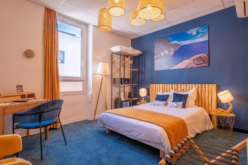 a bedroom with a bed and a desk and a window at Charlie's Hôtel Cannes in Cannes