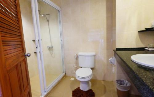 a bathroom with a shower and a toilet and a sink at Phu View Talay Resort in Pattaya South