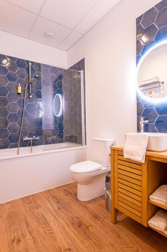 a bathroom with a toilet and a shower and a sink at Charlie's Hôtel Cannes in Cannes