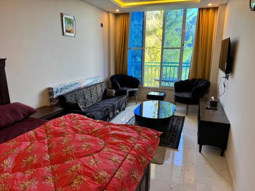 a living room with a bed and a couch at Swiss Suits, Suit 407 in Taiwāl