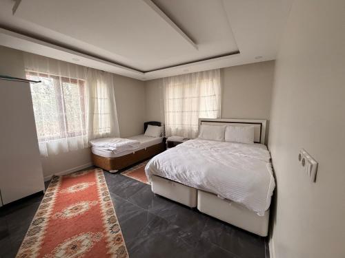 a bedroom with two beds and a window at Deluxe apart in Pamukkale