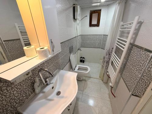 a bathroom with a sink and a toilet at Deluxe apart in Pamukkale