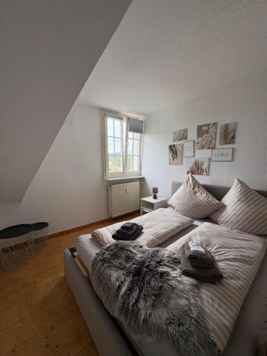 a bedroom with a large bed with blankets on it at Foundry ONE LoftQuartier in Jugenstilvilla in Wittlich