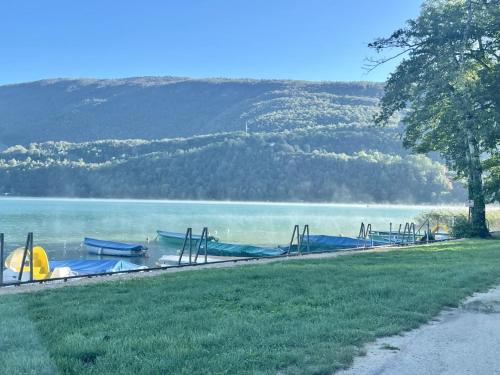 a park with a bunch of slides on a lake at Camping Onlycamp Les Peupliers in Lepin-le-Lac