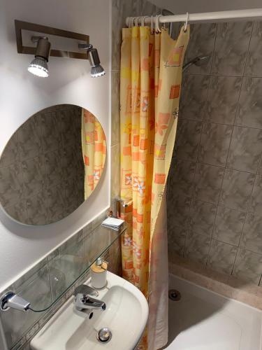 a bathroom with a sink and a mirror at Guest House Maija in Ventspils