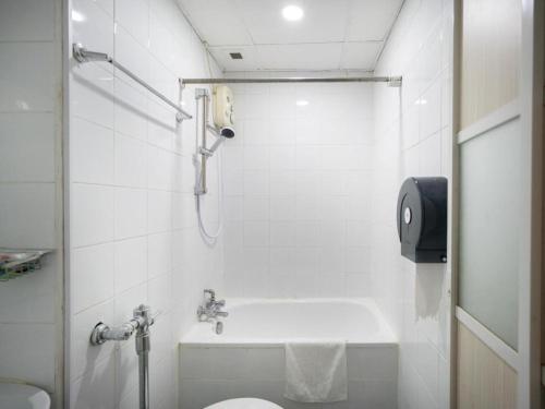 a white bathroom with a shower and a toilet at Hotel 165 in Singapore