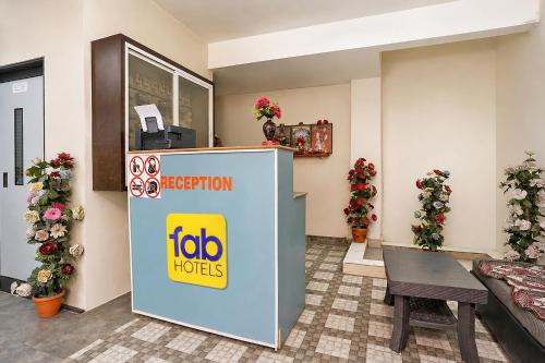 a hotel room with a tabo hotel sign in a room at FabHotel Saptshrungi in Nashik