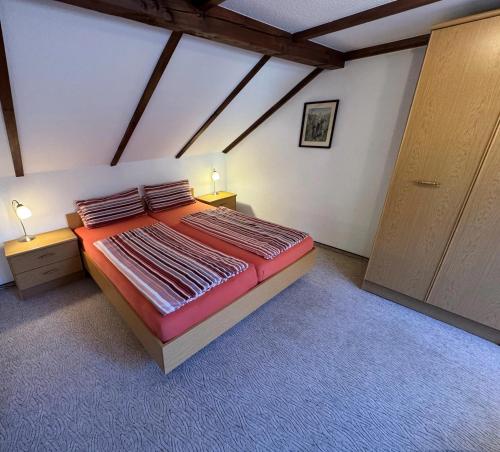 a bedroom with a large bed in a attic at Ferienhaus Klöber in Lichtenhain