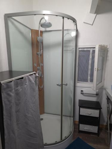 a shower with a glass enclosure in a bathroom at Le chalet de la tranquillité ! in Parignargues