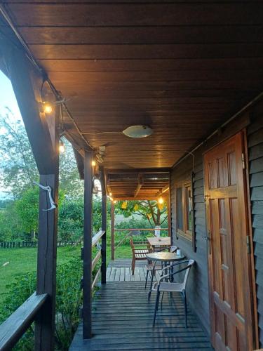 a porch of a house with a table and chairs at Domek Zapach Wyspy in Gdańsk