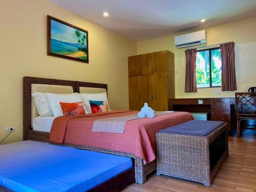 a bedroom with two beds with a teddy bear sitting on them at Infinity Sands Resort in Siquijor