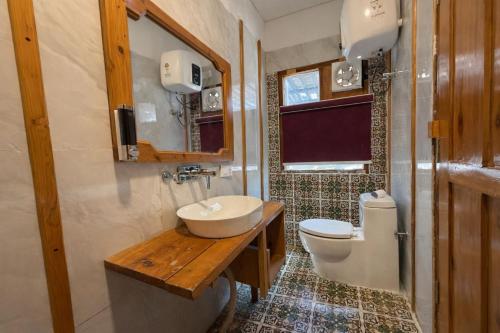 a bathroom with a sink and a toilet at Namami Harsil in Harsil