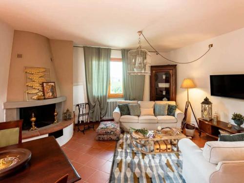 a living room with a couch and a table at Apartment Olearum in Panzano