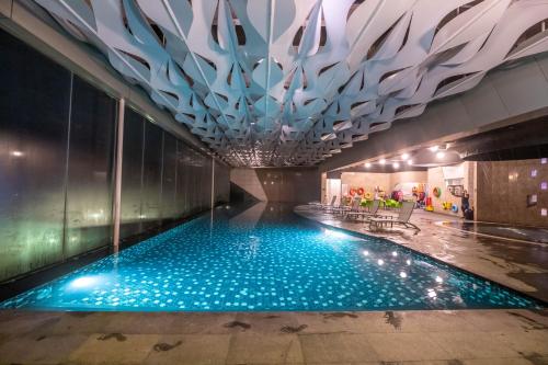 a swimming pool in a building with a ceiling at Premium Suites D'lement Genting Highlands by BYON in Genting Highlands
