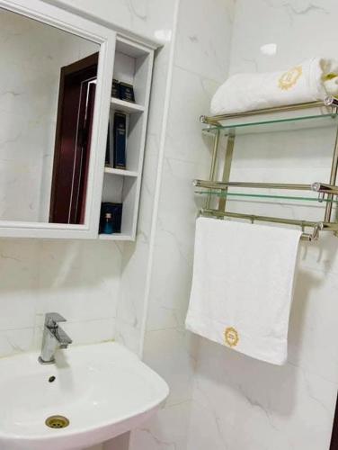 a bathroom with a sink and a mirror and towels at Khatanmandal in Dalandzadgad
