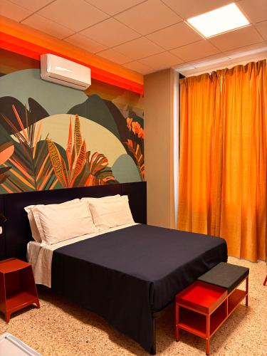 a bedroom with a large bed and a painting at Magazzino Mediterraneo in Praia a Mare