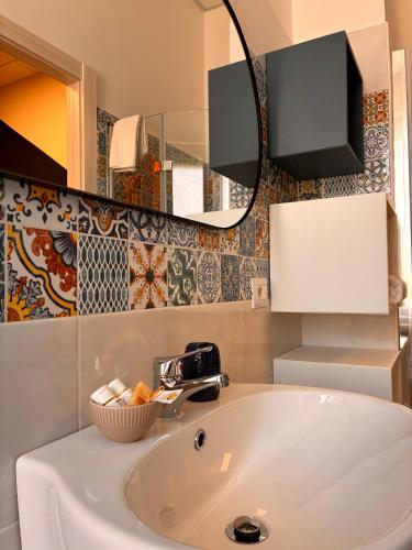 a bathroom with a sink and a mirror at Magazzino Mediterraneo in Praia a Mare