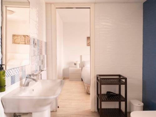 a bathroom with a white sink and a mirror at Aparthotel Ona Aucanada in Port d'Alcudia