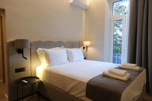 a bedroom with a bed with two towels on it at Essence 55 Living in Rhodes Town