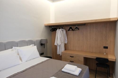 a bedroom with a bed and a desk and a desk at Essence 55 Living in Rhodes Town