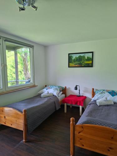 a bedroom with two beds and a window at Zakątek Turysty in Gdańsk