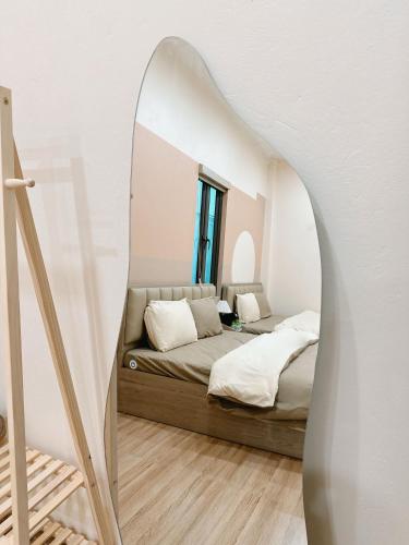 a bedroom with a bed and a mirror at A2 House Cát Bà in Cat Ba