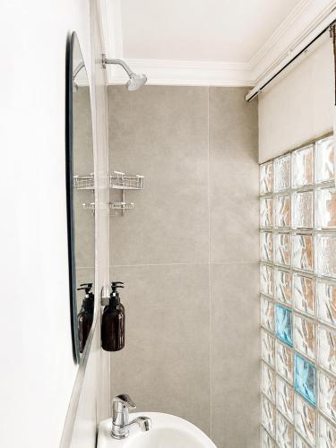a bathroom with a sink and a shower at Limonite Guesthouse in Pretoria