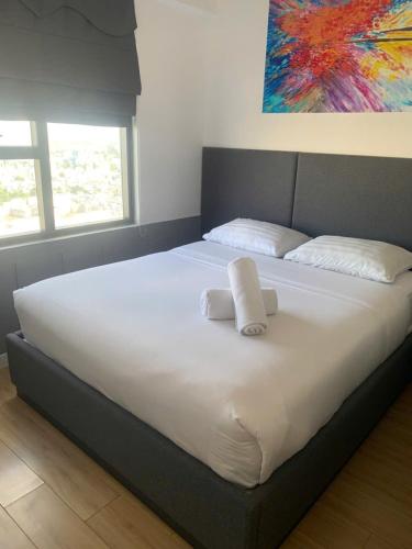 a large bed with two pillows on top of it at ARVO Cam Ranh - Infinity swimming pool in Cam Ranh International Airport