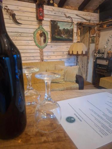 a living room with wine glasses on a table at Etno House Šćepanov Hlad in Virpazar