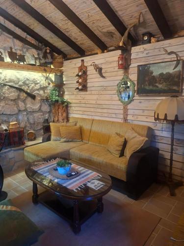 a living room with a couch and a table at Etno House Šćepanov Hlad in Virpazar