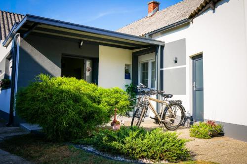 a bike parked outside of a house at Kuća za odmor BARBARELLA - prostrani 2BR apartman, parking & WiFi in Čakovec