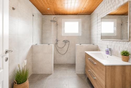 a bathroom with a shower and a sink at Beach House Cavo Kiotari in Gennadi