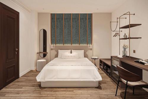 a bedroom with a large white bed and a desk at Ben Thanh Luxury Hotel - Premium Kas Dilly & Spa in Ho Chi Minh City