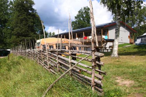 a wooden fence in front of a building at Vimmerby Camping in Vimmerby