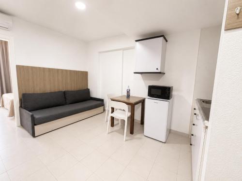 a small living room with a couch and a table at Apartamentos El Faro By Mc in Benidorm