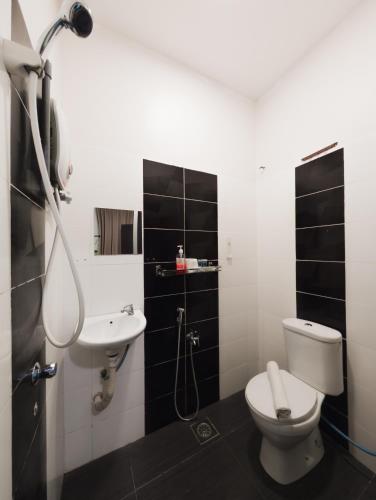 a bathroom with a toilet and a sink at Night Queen Express Hotel KLIA T1 and KLIA T2 in Sepang