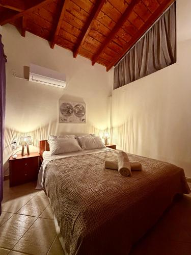 a bedroom with a bed with two towels on it at Blue Horizon Makri in Alexandroupoli